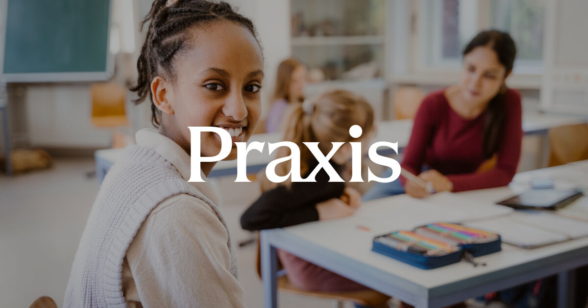 The word "Praxis" is superimposed on top of an image of a teacher working with two children. One child works at a table next to the teacher; the other child smiles and looks at us, the audience.